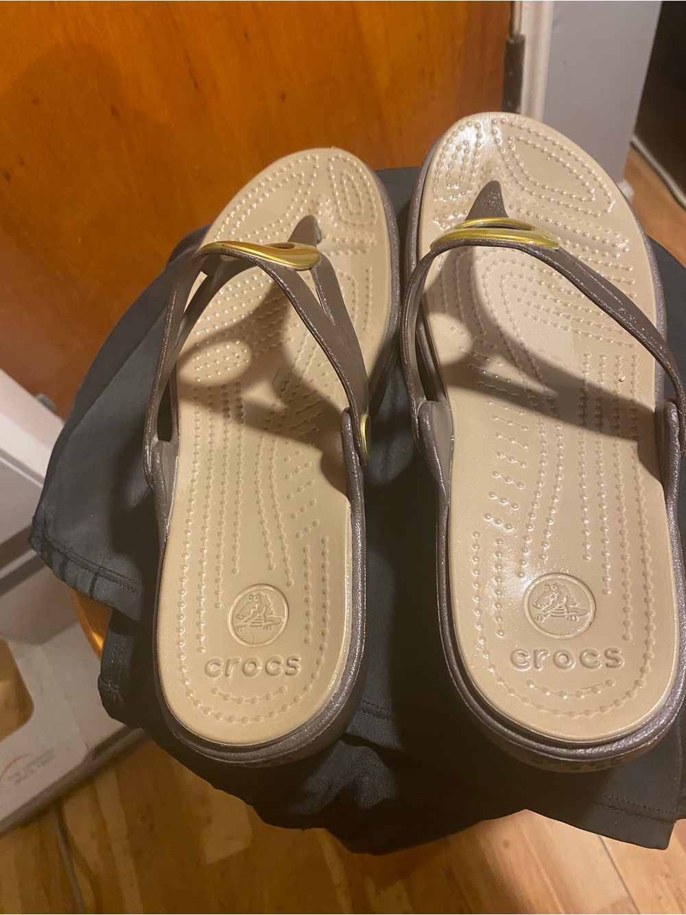 Crocs Sanrah Beveled Circle Wedge Sandals in the Espresso / Gold colorway.